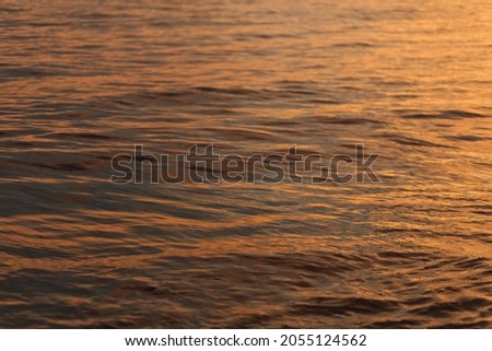 The texture of seawater during sunset or sunrise.