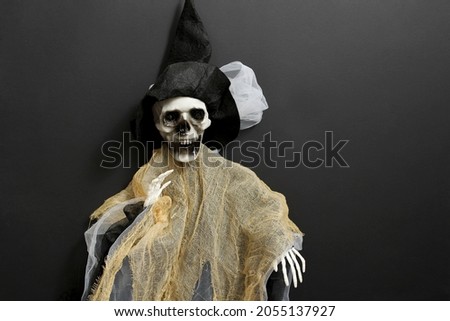 Halloween with a skeleton of a witch. Decorating the interior for the Halloween holiday.