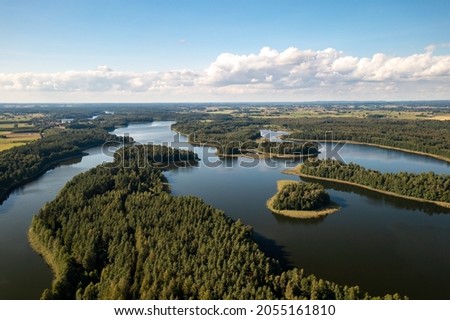 Aerial view of green islands and clouds at summer sunny day. Masurian Lake District in Poland.  Royalty-Free Stock Photo #2055161810
