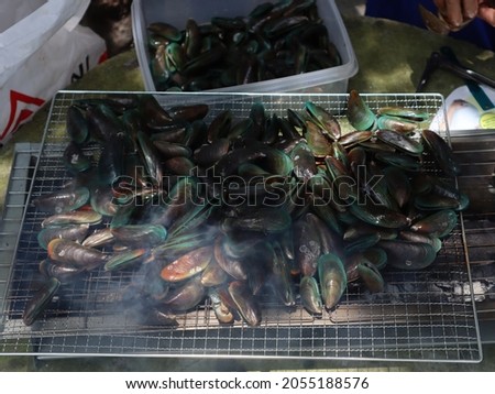 Picture of roasted mussels with charcoal