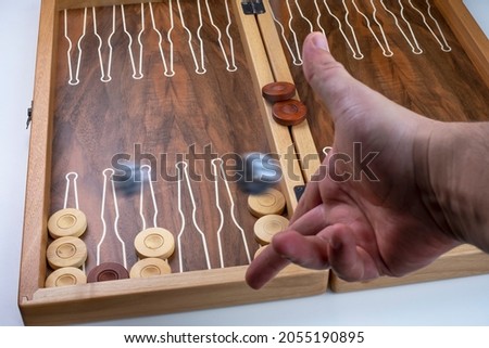 Moving dice hang in the air. Hand throws the dice on the background of Board games(backgammon). Selective focus. Known as 'tavla' in Turkish.