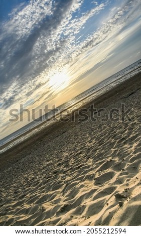 Idyllic sunset at Croyde Bay, surfing beach, Devon taken at a skewed angle