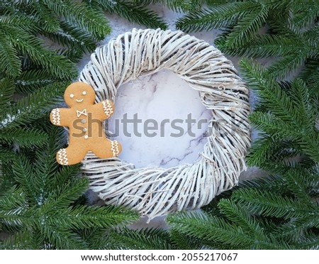 gingerbread man, wreath and fir tree branches. symbol of christmas and new year holidays. festive winter time concept. minimal composition. flat lay. copy space