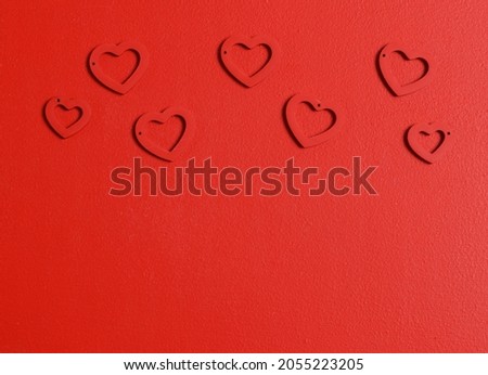 RED Hearts background. Valentine's Day decoration. Top view flatlay. Photo for children's party. Design of Greeting Card With 
wooden handmade figurines of hearts.red trending colors