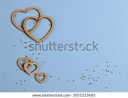 Hearts background. Valentine's Day decoration. Top view flatlay. Photo for children's party. Design of Greeting Card With 
wooden handmade figurines of hearts. trending colors