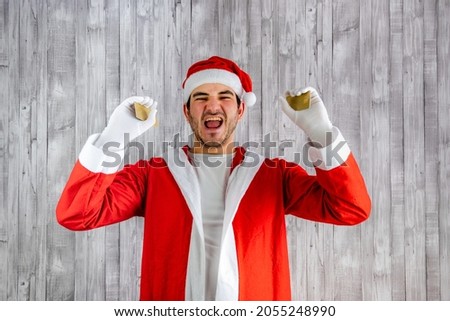 Man in Santa Claus costume with two credit cards