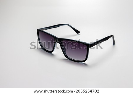 Black sports glasses on white background. Side view. Space for text. Royalty-Free Stock Photo #2055254702