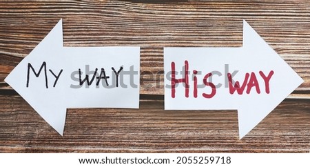 God Jesus Christ way of life. Choose the path to eternal life. Follow God. The biblical concept of godly wisdom, guidance, leading, and Christian growth. Handwritten words on paper arrows. A closeup. Royalty-Free Stock Photo #2055259718