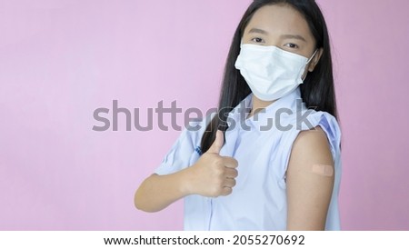 Asian student vaccination on pink background.