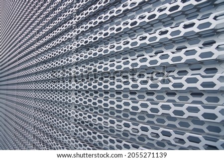 structural skeleton of metallic perspective construction shape gray industrial wall background cells surface, focus on middle of picture, unfocused foreground 