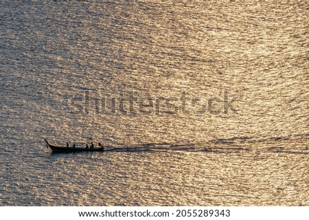 Thai fishing boat at sunset from Cape Promthep Phuket