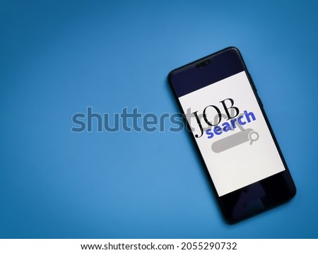 Job search application on smartphone screen with copy space.