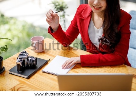 Shot of an Asian young business Female working on laptop computer in her workstation.Portrait of Business people employee freelance online marketing e-commerce telemarketing concept.