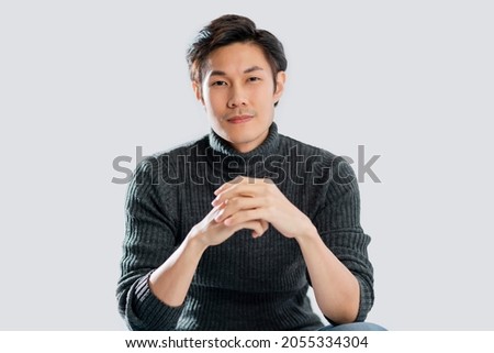 portrait lifestyle studio shot white background of young smart active asian male wear sweater smile with positive emotion and confident relax casual asian male white background Royalty-Free Stock Photo #2055334304
