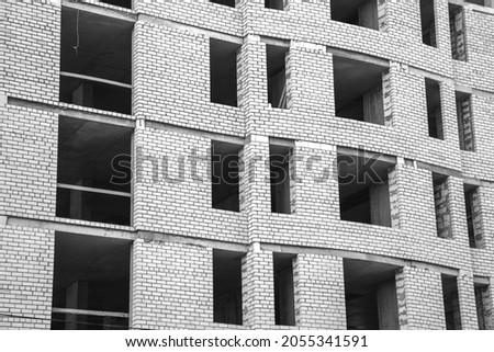 Industrial construction site, concrete walls with briks background photo