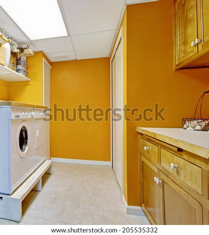 Bright yellow laundry room with white appliances