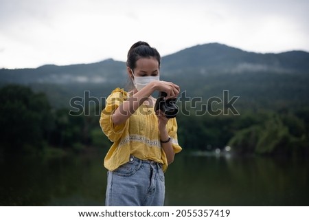 Series photo of Young women wearing surgical protection mask playing with camera in the evening , freedom , actvity and recreation concept