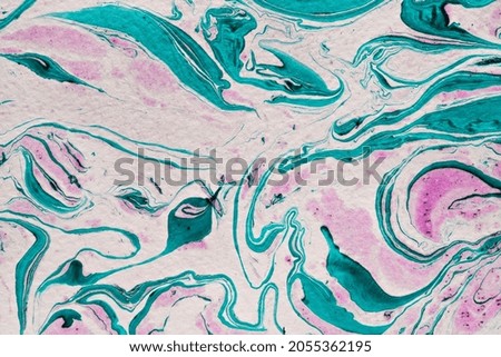 Abstract DIY marble background pattern in free flowing waves and curls of purple, blue pink and white pigment in a full frame texture