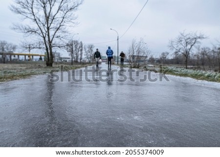 Slippery road covered ice. Frozen winter way after freezing rain Royalty-Free Stock Photo #2055374009