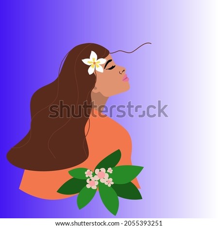 Portrait of a young woman with a beautiful face and a tropical flower in her hair. Side view. The concept of happiness and peace on a blue gradient background with a copy of the space.