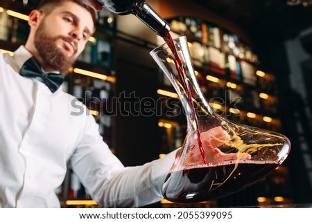 Young handsome man sommelier tasting red wine in cellar Royalty-Free Stock Photo #2055399095