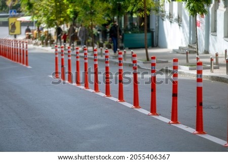 Red and white striped poles in the row