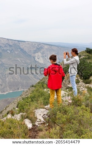 mother and son take a photo of the scenic Sulak canyon in Dagestan
