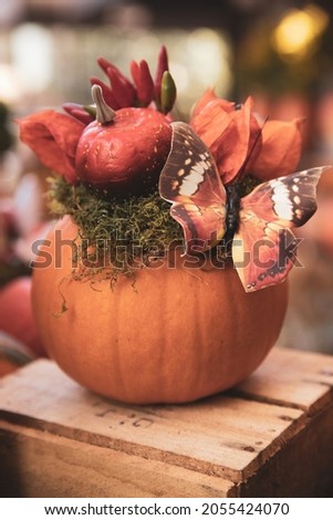 Decorated Halloween pumpkin on the table in the greek garden shop. October, 2021.