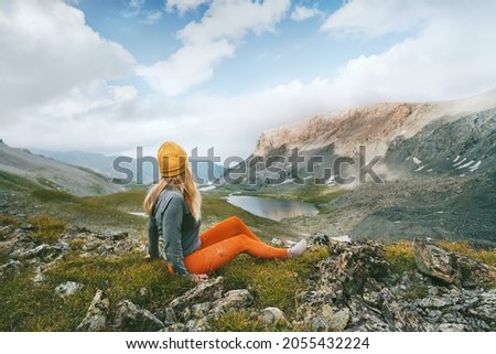 Hiker woman looking at lake and mountains view travel hiking alone outdoor active vacations adventure lifestyle solo trip  Royalty-Free Stock Photo #2055432224