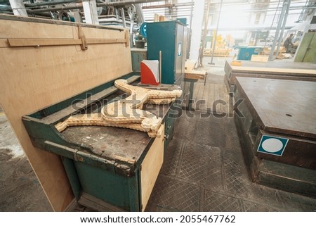 Woodwork factory with stacks of wood and equipment machinery. Professional industrial carpentry manufacturing