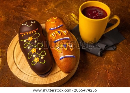 White and brown guaguas de pan with colada morada. Ecuadorian traditional food on the day of the dead Royalty-Free Stock Photo #2055494255