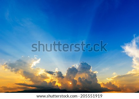 dramatic Sunset with sun rays through clouds 
