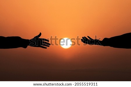 Human hand Asking help Concept. hands helping each other Against Sunset background. People helping, God salvation and Get Hired Concepts Royalty-Free Stock Photo #2055519311