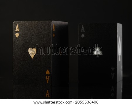 Black poker cards on a dark background. Minimalism. There are no people in the photo. Casino. nightclub, gambling, poker, risk. cash flows. Gambling business.
