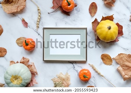 Thanksgiving day, harvesting mockup. Blank poster frame and autumn decorations. Flat lay design. Mockup poster for Thanksgiving day congratulations.