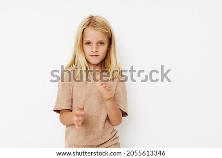emotional girl in a beige t-shirt posing studio