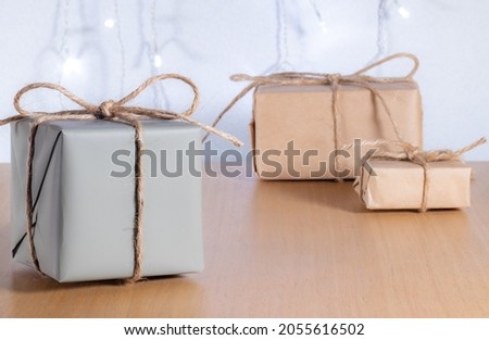 Christmas gifts in craft style on background of bokeh of lights. Selective focus, High quality photo