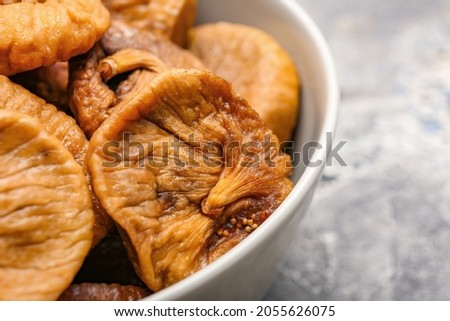 Bowl with tasty dried figs, closeup