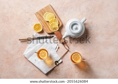 Composition with cups of hot healthy tea on color background