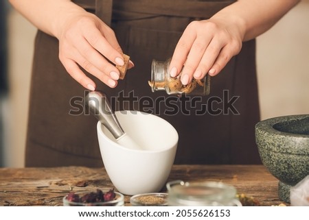 Female alchemist making elixir in laboratory Royalty-Free Stock Photo #2055626153