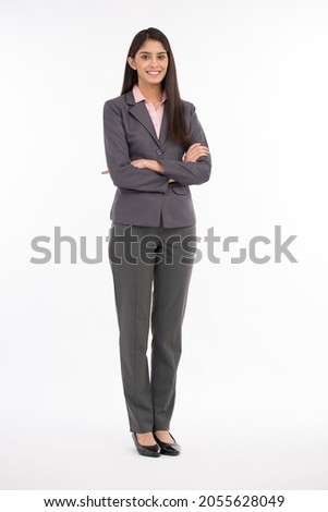 Confident Businesswoman against white background studio shot.