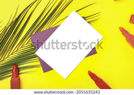 Composition with blank card, envelope and makeup cosmetics on color background