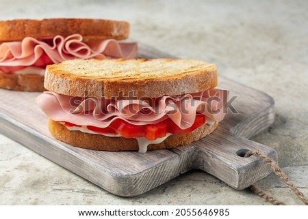 Mortadella sandwich. Toasted bread, italian soft cheese, tomatoes and sliced mortadella. Royalty-Free Stock Photo #2055646985