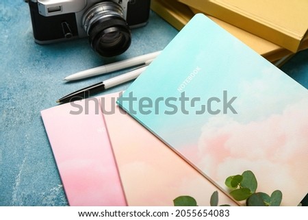 Different notebooks on color background, closeup