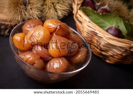 Chestnut dessert and chestnuts on a plate. Traditional delicious Turkish dessert; chestnut candies (Kestane Sekeri) Royalty-Free Stock Photo #2055669485