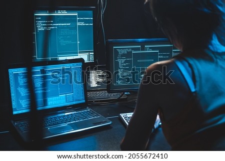 Software developer freelancer woman female  work with program code on computer wide displays at night Develops new mobile application Coder work software program Programmer at night, Visualizing Data Royalty-Free Stock Photo #2055672410