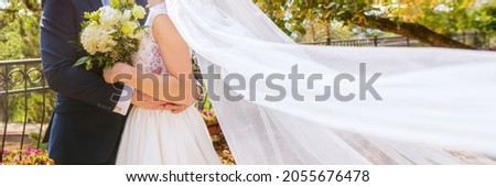 Cropped shot of an affectionate young newlywed couple embracing eachother on their wedding day. Just married husband and wife panoramic banner. Wedding and love concept.