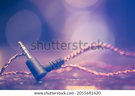 Music background with headphone jack close-up with beautiful lighting.