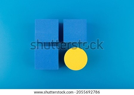Blue toy cubes and yellow circle on dark blue background. Concept of individuality, being different from others, leadership or unique ideas  Royalty-Free Stock Photo #2055692786