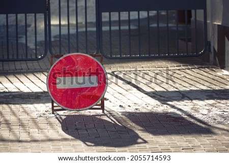Stop sign standing in front of closed gate. Warning sign, car park closed. Do not park in front of the gate
